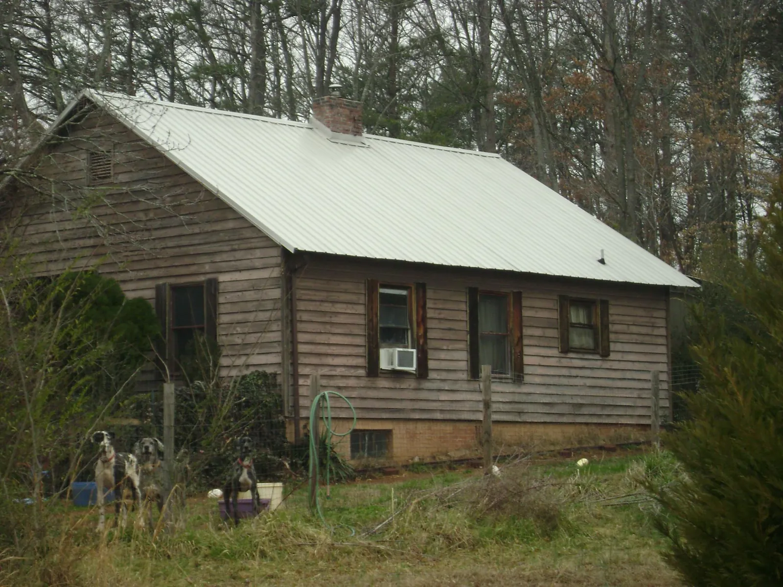 White metal roof on an old wood sided farmhouse, from a Metal Roof Installation job in Malinta